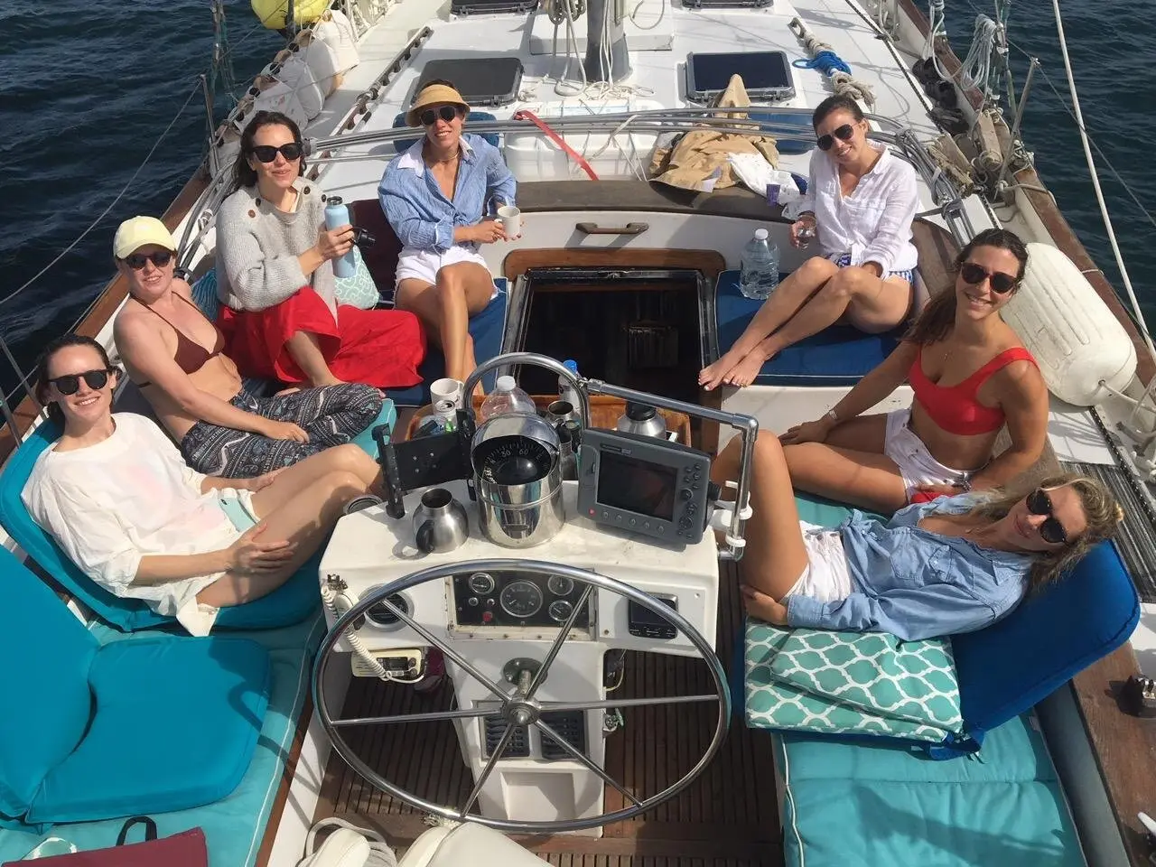 Bachelorette party guests relaxing together in the cockpit