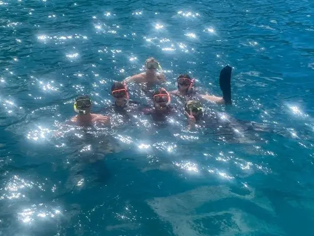 Six snorkelers floating in the clear water of the Virgin Islands