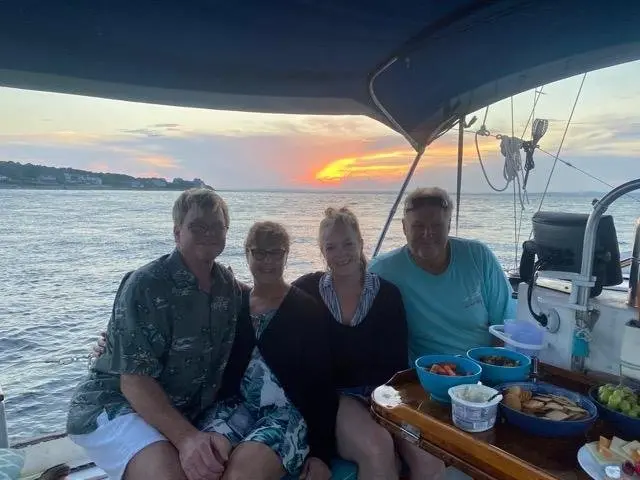 Guests enjoying snacks on deck at sunset