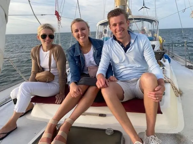 Three guests enjoying the breeze on the bow