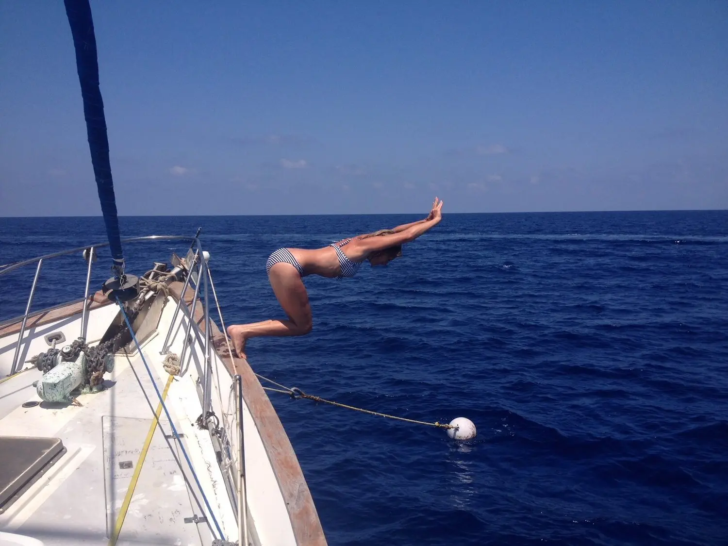 Guest diving off the yacht Tandemeer into the water